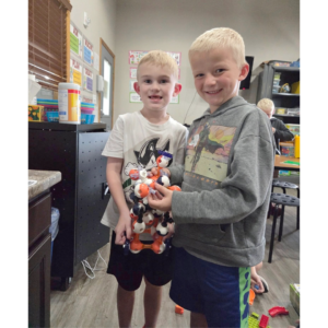 Two boys smiling at the camera.