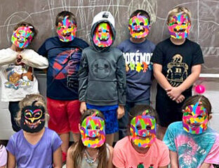 Students in masks they made
