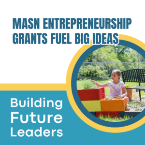 Girl sitting next to a flower pot in the afterschool program's garden