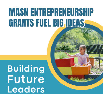 Girl sitting next to a flower pot in the afterschool program's garden